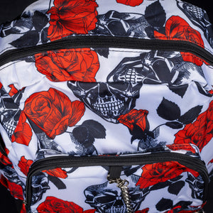 	Close-up of skull and rose pattern on front of backpack – A close-up on the front panel, highlighting the detailed black skull and red rose pattern on a white background, adding a pop of colour to the gothic aesthetic.