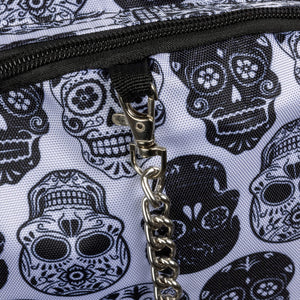 Close-up of the silver chain detail and black sugar skull print on a white gothic backpack by CHOK GothX. The intricate pattern and quality materials reflect the brand's alternative style for bold fashion lovers.