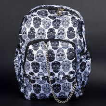 Load image into Gallery viewer, A white gothic backpack with a black sugar skull print and silver chain detail by CHOK GothX. The bag features spacious compartments, sturdy zippers, and a bold alternative design, ideal for fans of edgy and spooky fashion styles.
