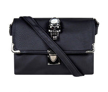 Load image into Gallery viewer, The GothX crystal skull vegan shoulder bag on a white studio background. The bag is facing forward to highlight the crystal skull centrepiece, metal clasp clip close, metal corner detailing and detachable strap.
