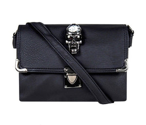 The GothX crystal skull vegan shoulder bag on a white studio background. The bag is facing forward to highlight the crystal skull centrepiece, metal clasp clip close, metal corner detailing and detachable strap.