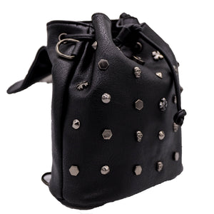 The GothX crystal skull vegan tassel tie backpack on a white studio background. The bag is facing forward angled right with the magnetic close clip flap open to highlight the tassel tie cords and cross, hexagon, cone and skull studs.