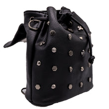 Load image into Gallery viewer, The GothX dont cross me vegan tassel tie backpack on a white studio background. The bag is facing right with the main flap open to highlight the tassel tie cord close, hexagon, cone, cross and skull studs, and magnetic close clip.
