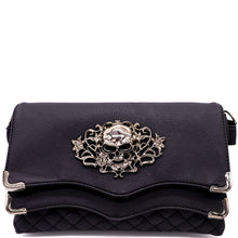 Load image into Gallery viewer, The GothX Skulls and Roses Quilted Clutch Bag shown on a white studio background. The vegan leather clutch bag is facing forward and being opened to highlight the two magnetic clip close flaps with metal corners, a stitch quilted front, a skulls and roses metal centrepiece and two D rings on either side for a detachable strap. The mini bag is inspired by gothic grunge witchy fashion.
