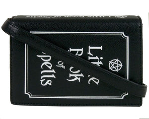 The gothx little book of spells vegan shoulder bag on a white studio background. The bag is resting on the 3d book edge shape to highlight the white printed pentagram and text front, white printed spine and detachable strap.