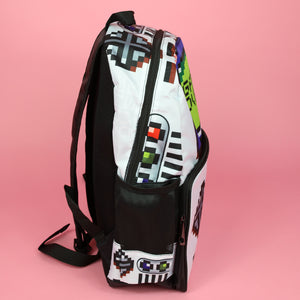 The white game over vegan backpack on a pink studio background. The bag is facing right to highlight the front game boy inspired print, front zip pocket and side pockets. The backpack features a 90s inspired gameboy print with buttons and a screen saying game over.