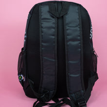 Load image into Gallery viewer, The black game over vegan backpack on a pink studio background. The bag is facing away to highlight the plain black back, side pockets, padded shoulder straps and top handle.
