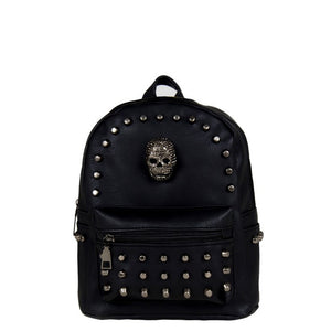 The GothX skull head small studded vegan mini backpack on a white studio background. The black gothic style vegan leather bag is facing forward to highlight the diamanté style skull, gunmetal coloured studs and front zip pocket.