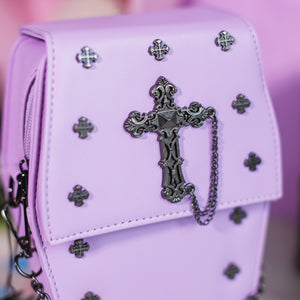Close up of the mini cross studs, cross chain centrepiece and the magnetic clip close of the GothX Pastel Lilac Mini Coffin Vegan Cross Body Bag.
