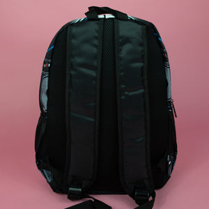 The retro black 80s stereo vegan backpack on a pink background. The bag is facing away to highlight the plain black back, two side pockets, top handle and padded adjustable shoulder straps.