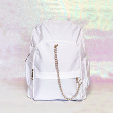 Load image into Gallery viewer, The white nylon vegan backpack with chain on an iridescent background. The bag is facing forward to highlight the two front zip pockets, two side pockets, double zip main compartment, top handle and detachable silver chain.
